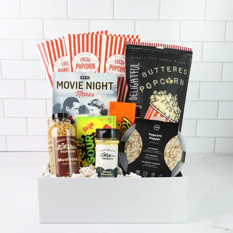 Movie night gift basket with popcorn, snacks, and a menu on a white background